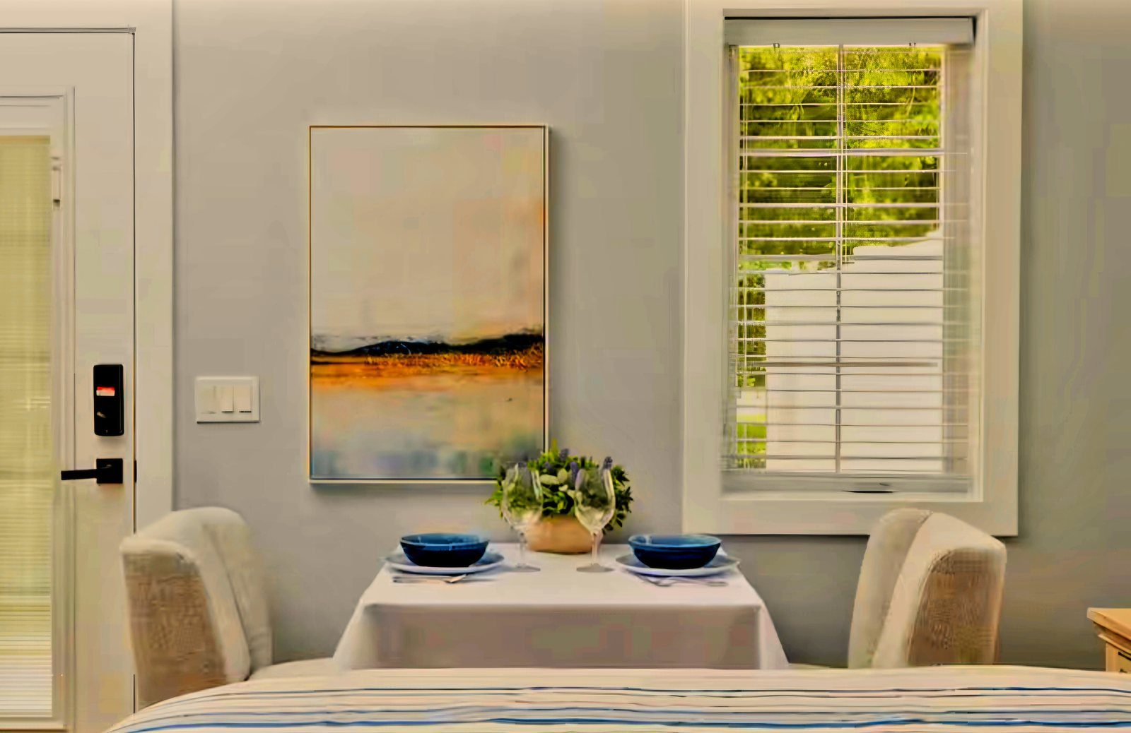 Dining table for two with chairs and window in Queen Suite